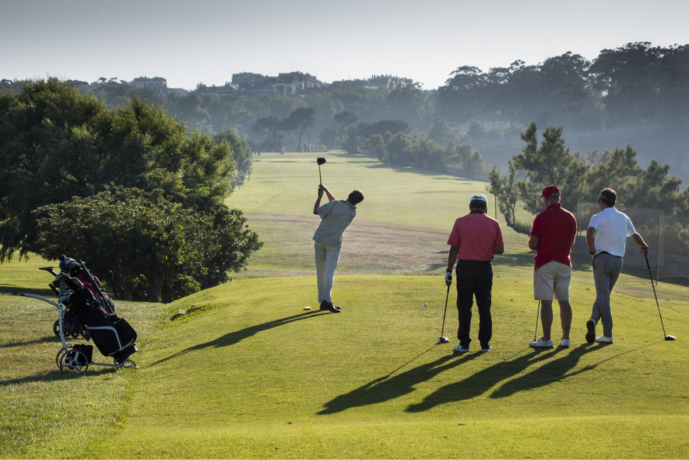 golf course teeing off in group of four