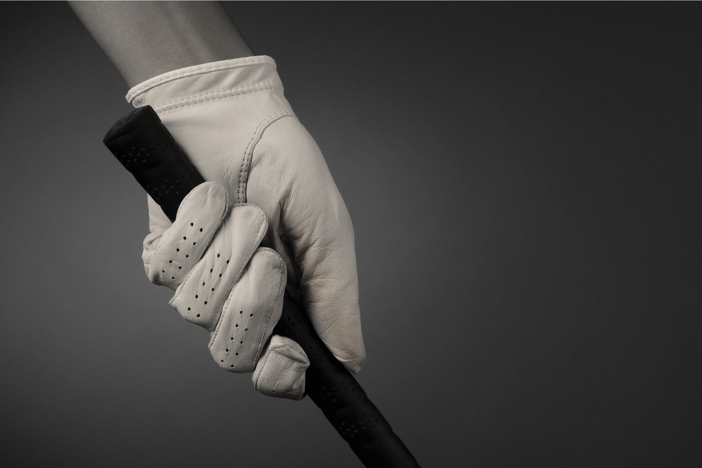 golfing glove holding club