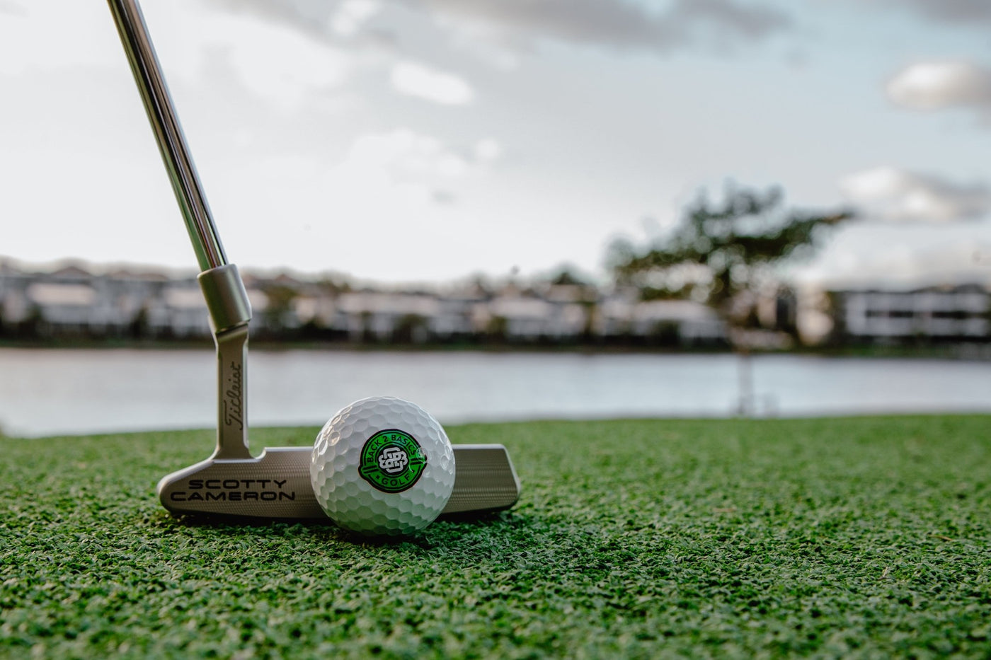 close up of putter and ball on course