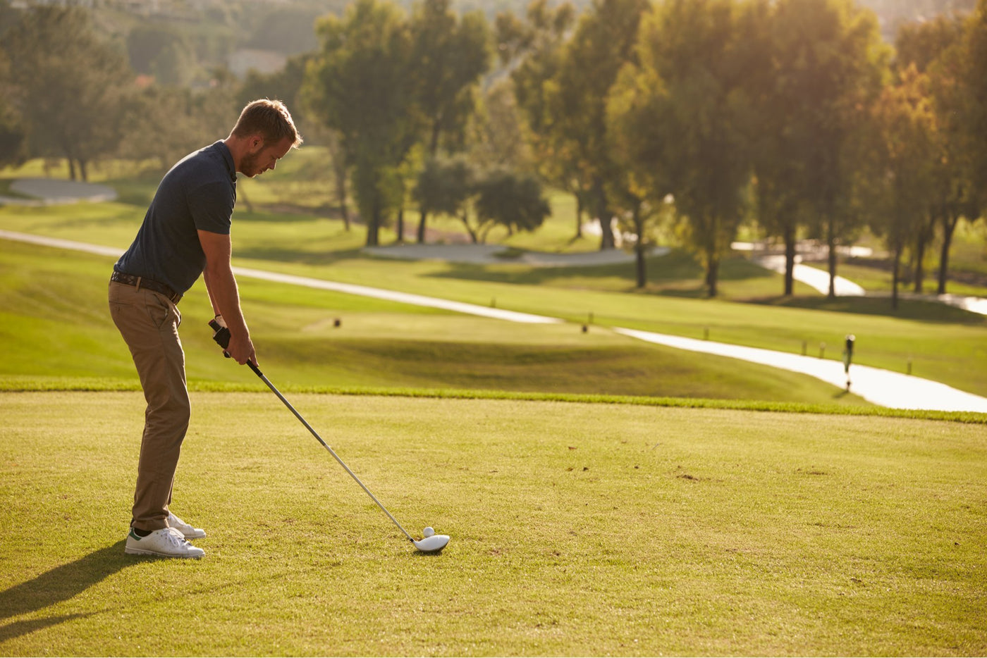 golfer getting ready to hit ball on course 