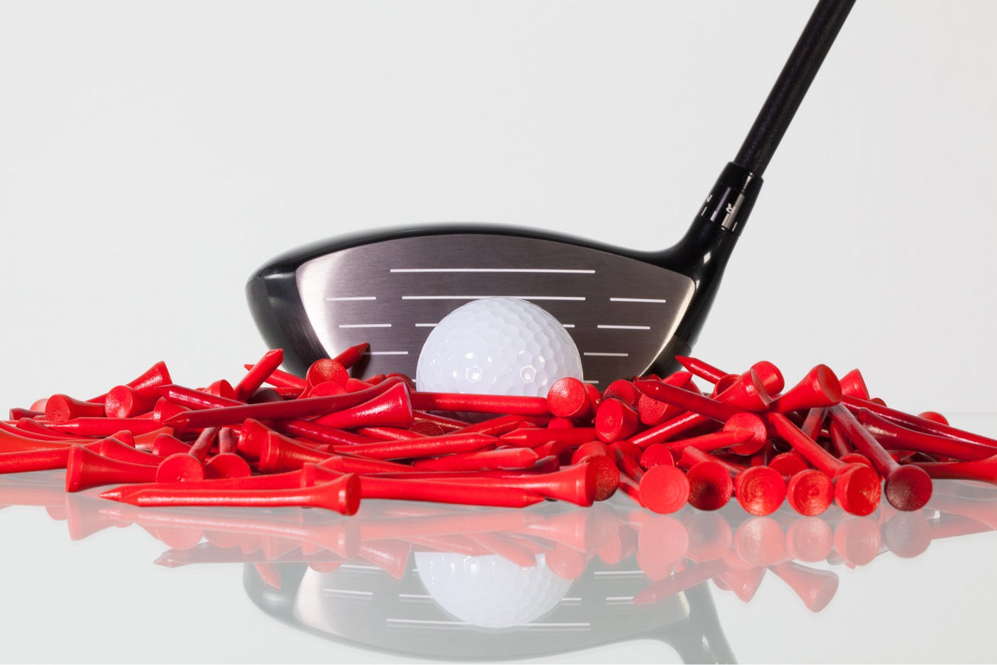 golf driver and ball close up with red tees