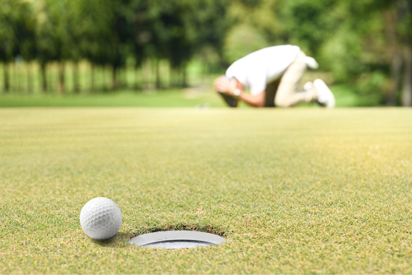 golf ball narrowly misses hole