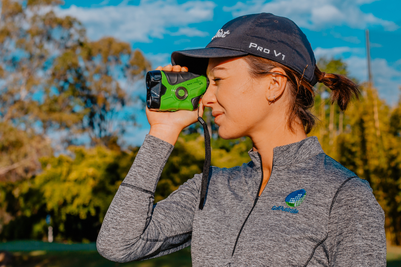 woman using a back2basics golf rangefinder